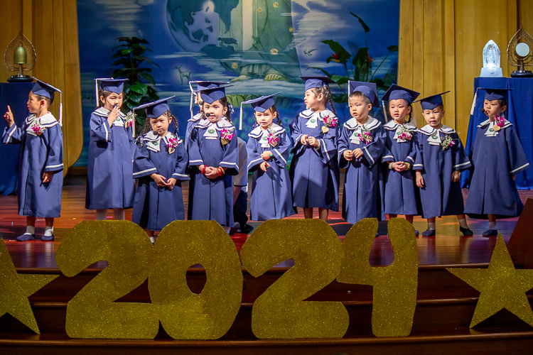 In this moving up ceremony, 15 students advance from pre-kindergarten to kindergarten.