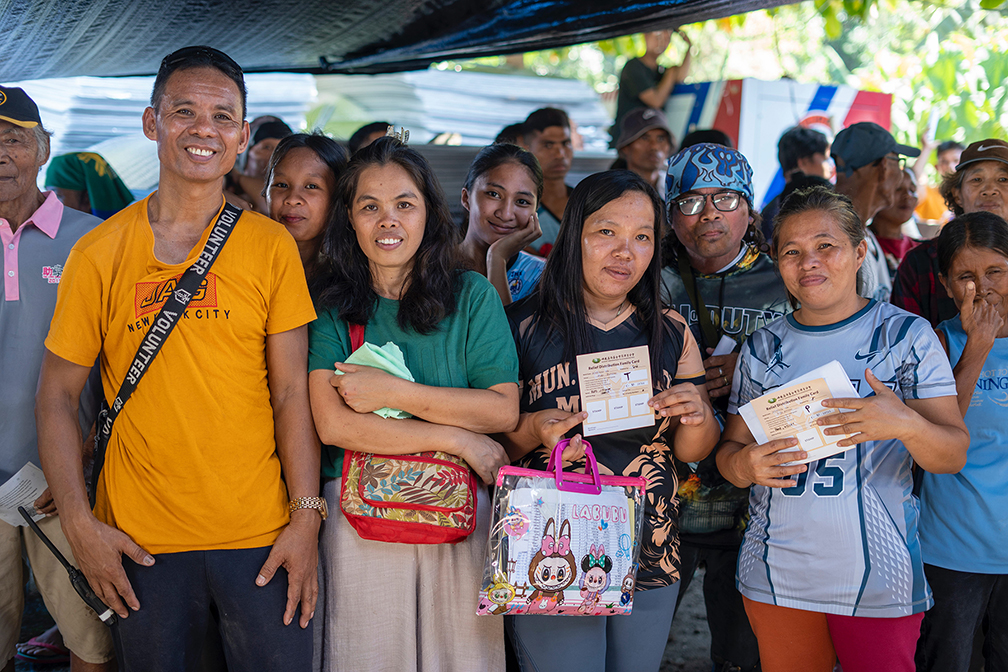 Despite the hardship of losing everything they own from the quake, residents from Butulan, Jose Abad Santos, smile after receiving their claim stubs. 