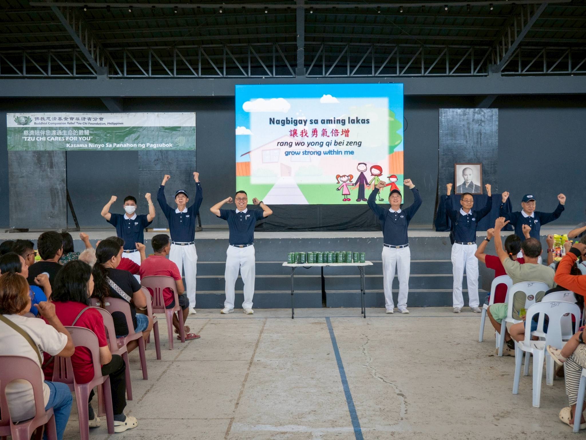 Tzu Chi volunteers perform the sign language song “Isang Pamilya,” a reminder that in times of hardship, we are one family united in heart. 