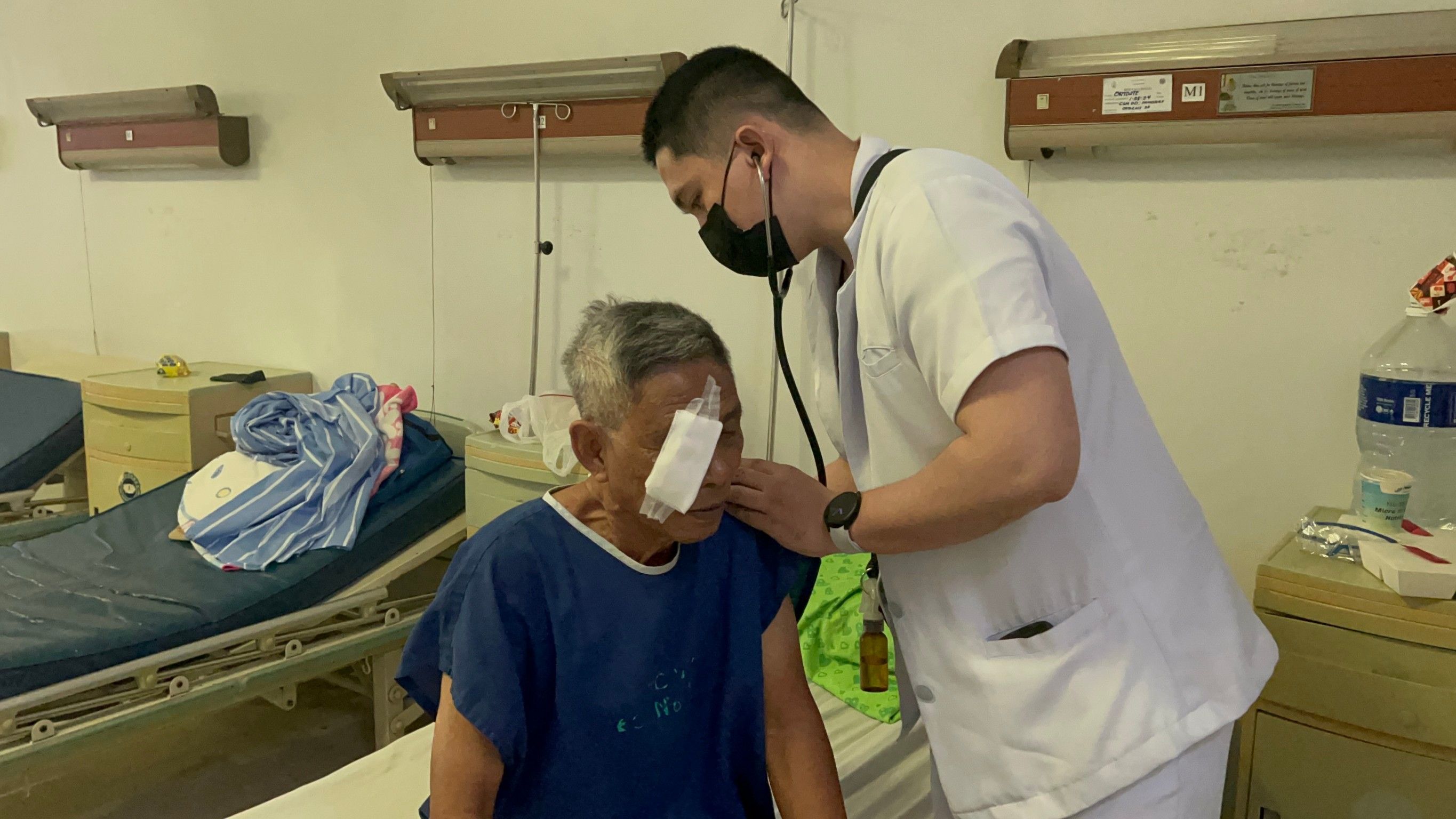 Edil-Joshua Ganas helps patients during check-ups.