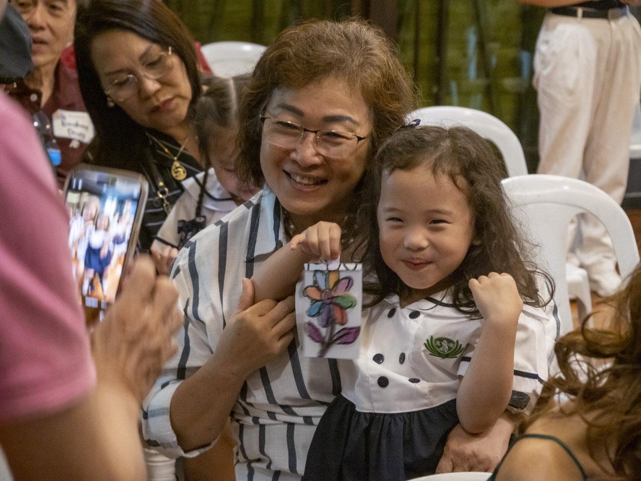 Joyful smiles are present as families take memorable photos together during the celebration of Grandparents Day.