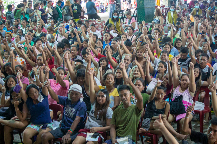 Beneficiaries show a gesture of gratitude.