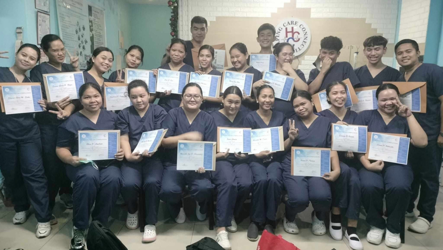 Tzu Chi Foundation’s Caregiving Scholars Batch 2023 gather for a photo as they receive their certificate of completion for a caregiving course.