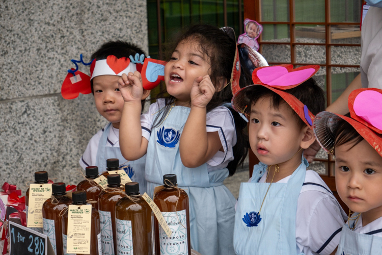 A student cheers on, anticipating the start of the kiddie market. 