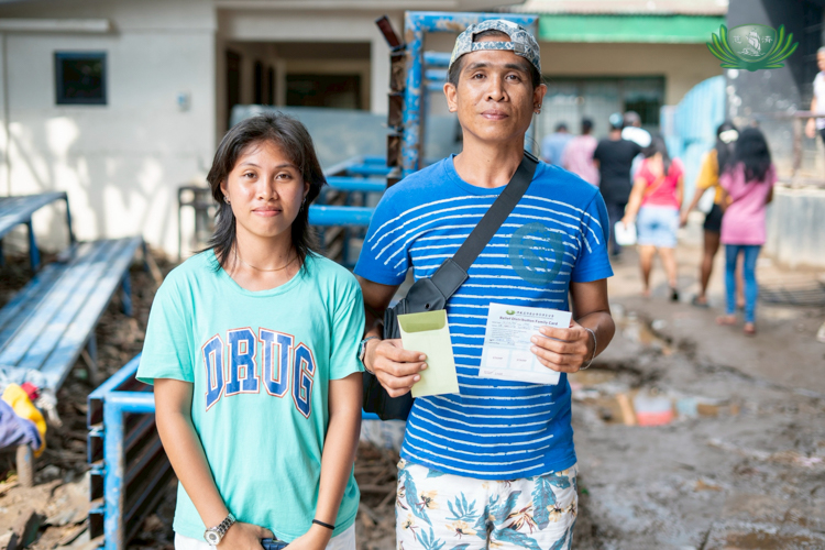 The Noble family, who were separated during the flood, came together to claim relief goods and financial assistance after their home was completely washed away.