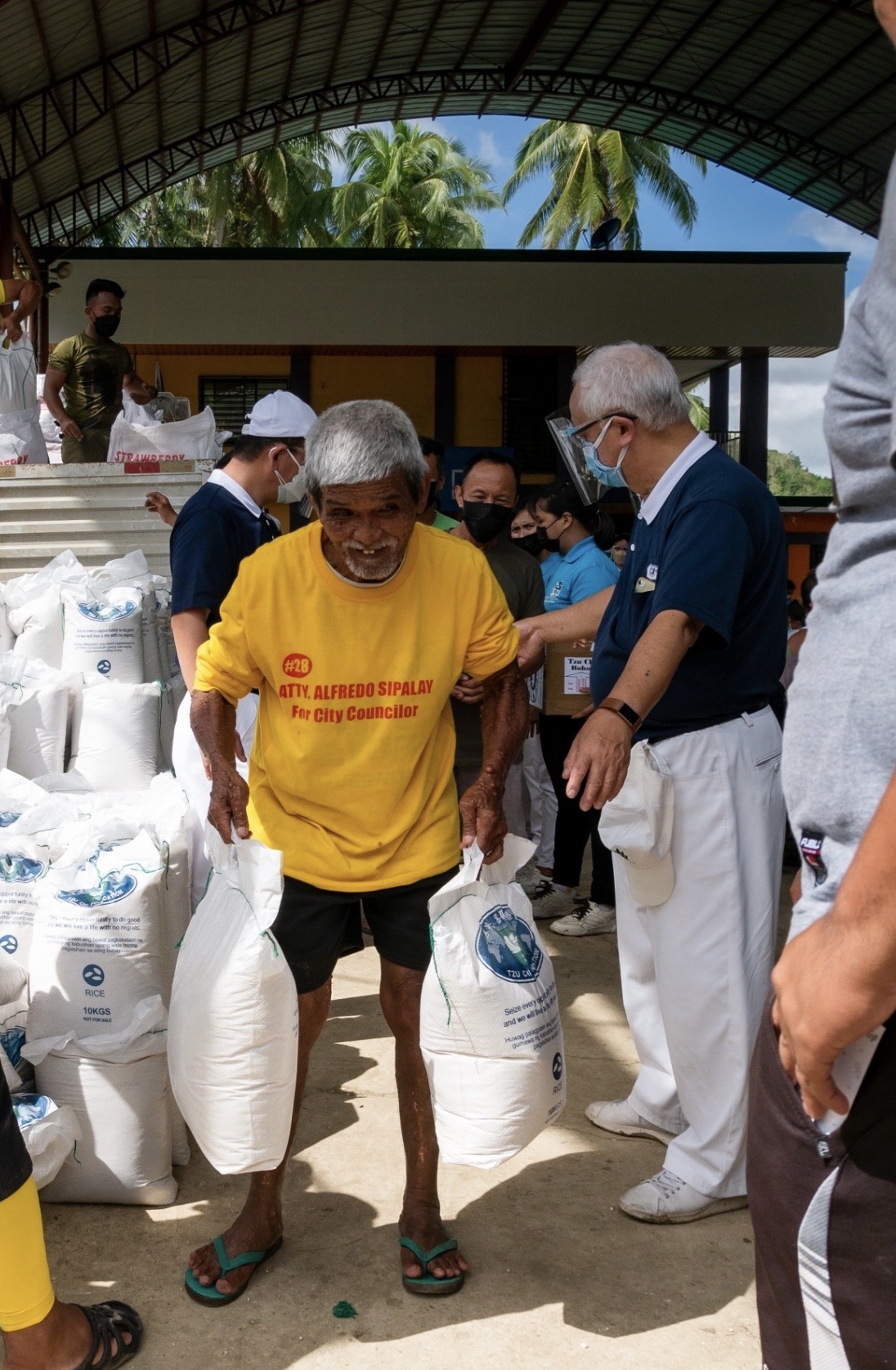 Tzu Chi volunteers are posted in various areas of the rice distribution process, guiding beneficiaries every step of the way.  【Photo by Daniel Lazar】