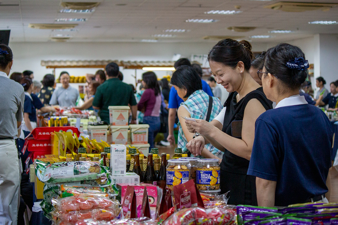 Filled with warmth and excitement, Harmony Hall welcomes shoppers as they joyfully choose items to take home.