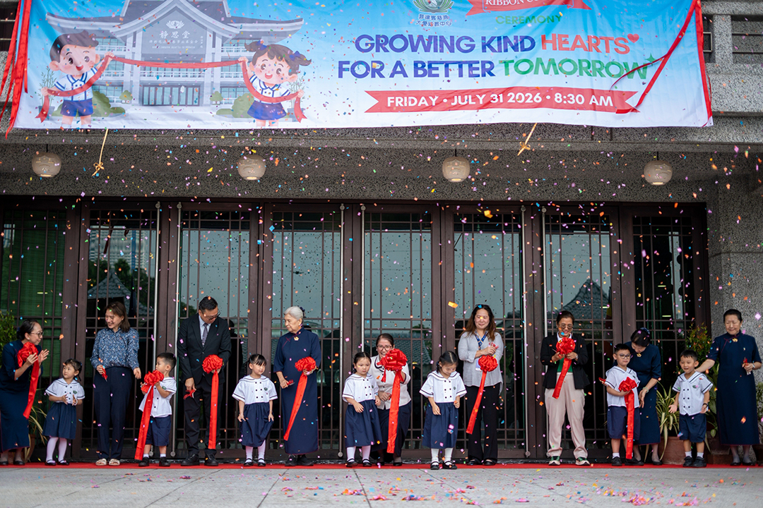 The ribbon is cut! Confetti showers the crowd as everyone celebrates the official opening of kindergarten.