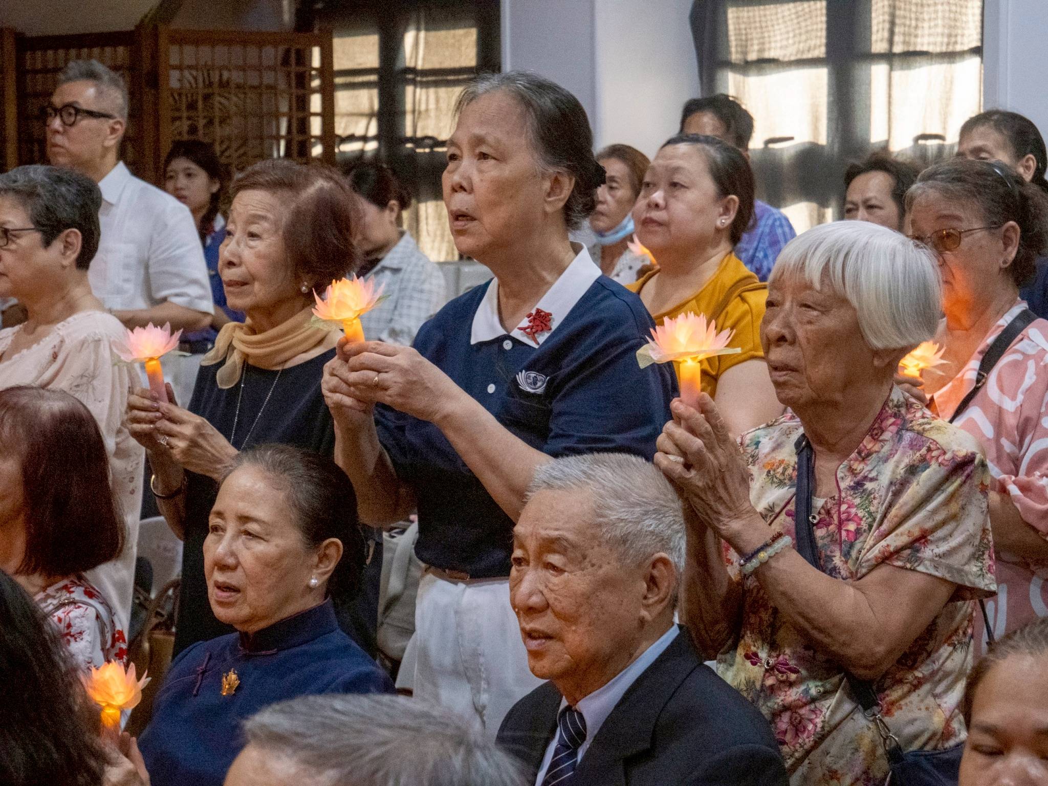 Guests and attendees pause for a shared moment of reflection and prayer.