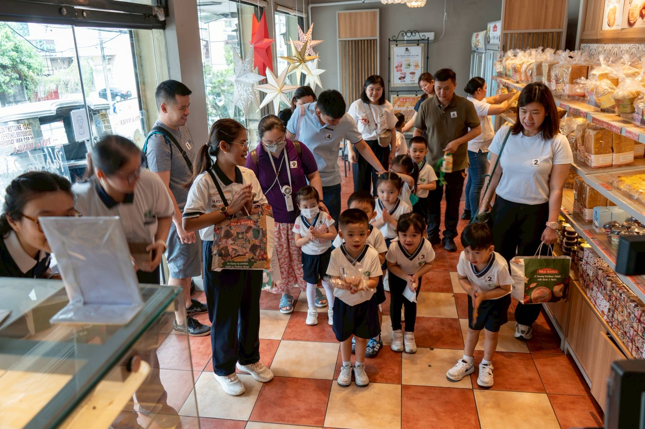 The pre-kindergarten class bows in gratitude to thank the breadshop staff for their service.