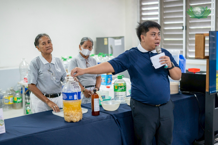 Tzu Chi volunteer Wilfredo Ortiz explains how the multipurpose, chemical-free cleaner enzyme is made.
