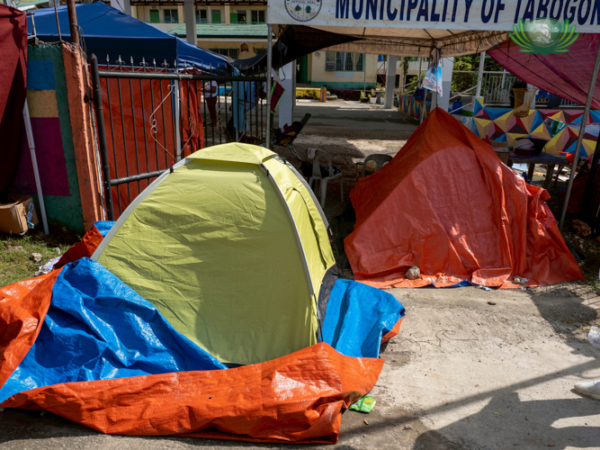 Tents made of tarpaulin serve as temporary shelter for families with totally damaged homes.
