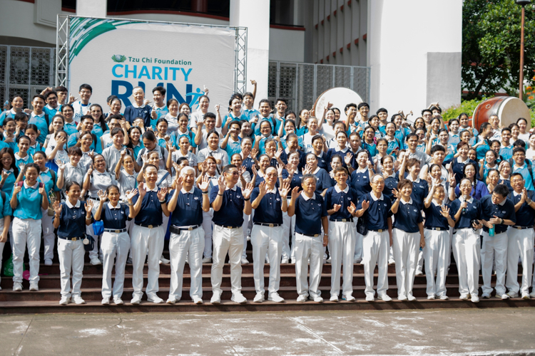 Tzu Chi scholars and volunteers pose for a photo at the Palma Hall steps to cap off the event.