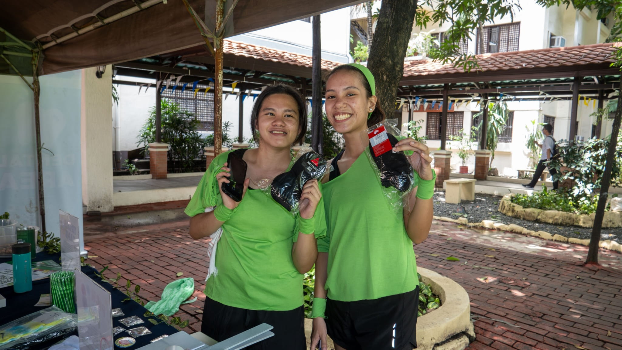 Justine Sartorio (left) and Mary Grace Castillejos show off the prizes they won in Tzu Chi’s trivia game.