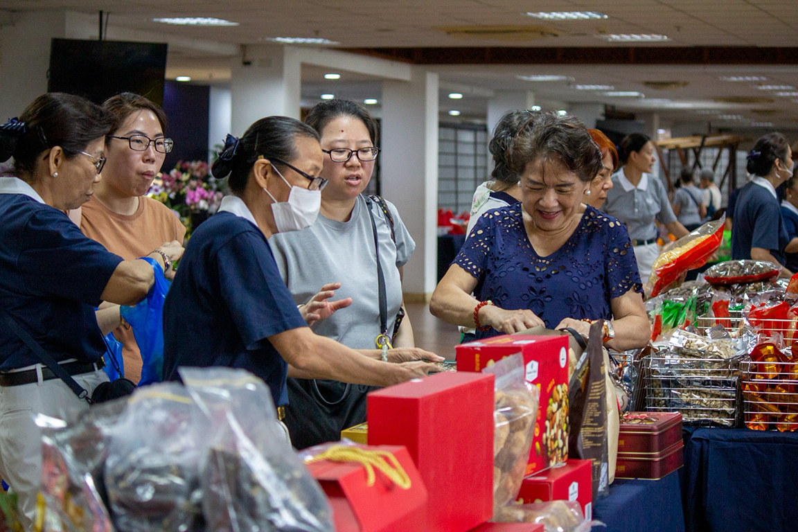 Filled with warmth and excitement, Harmony Hall welcomes shoppers as they joyfully choose items to take home. 