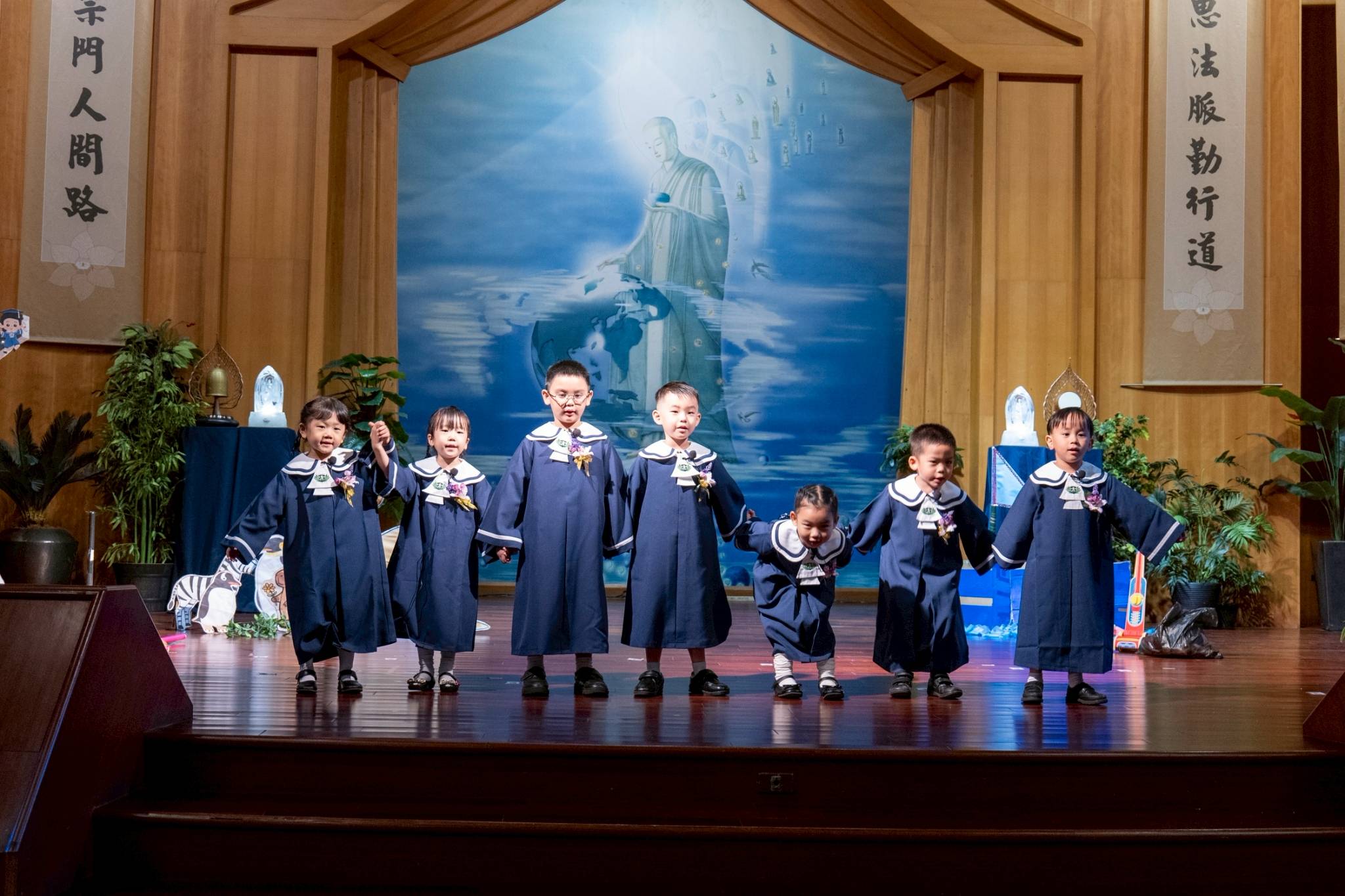 Pre-kindergarteners bow after acting in a skit on environmental protection and care. 