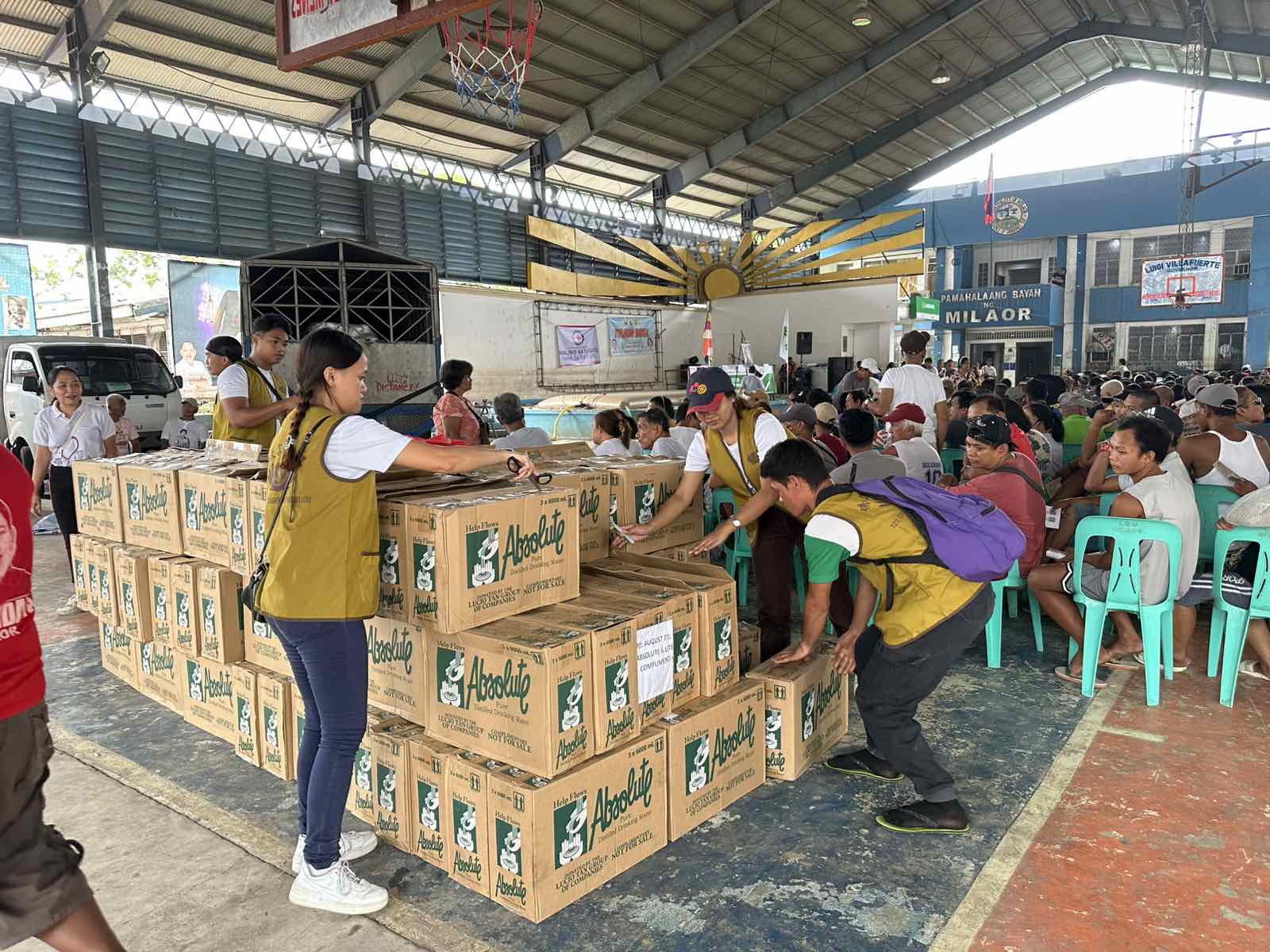 In Milaor, Camarines Sur, volunteers prepare the bottles of Absolute Distilled Drinking Water donated by Asia Brewery, Inc. 