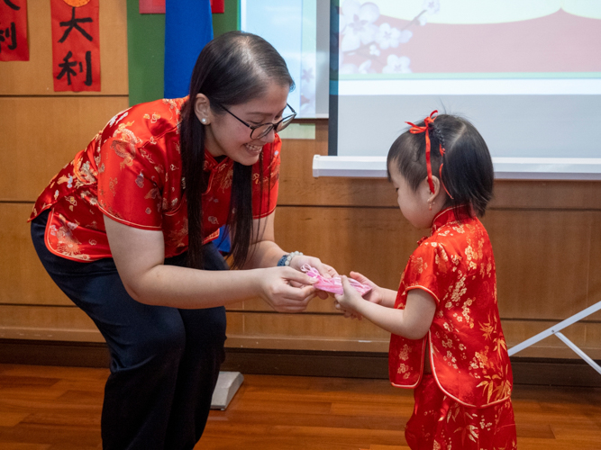 Tzu Chi Great Love Preschool Philippines Directress Jane Sy presents each preschooler with a token. 