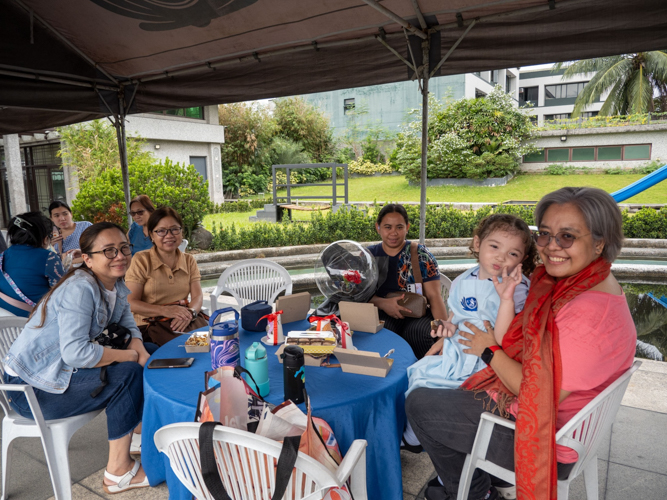 Parents share fun conversations with each other during the kiddie market. 