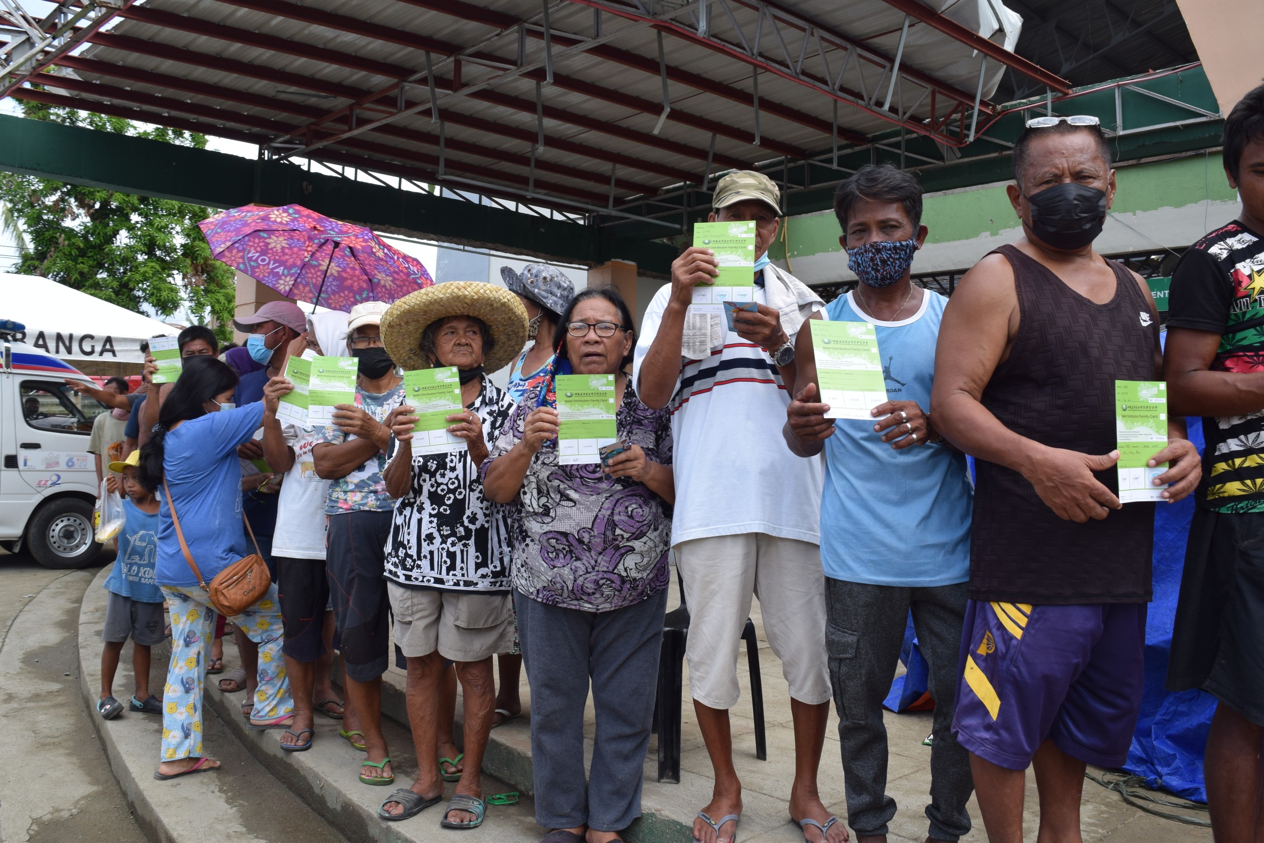Beneficiaries display the relief stubs for claiming their GI sheets. 