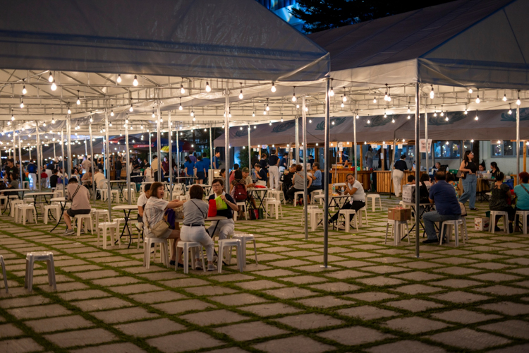 Shoppers came at all hours, including the evening when guests enjoyed a vegetarian dinner at the plaza under lighted canopies. 