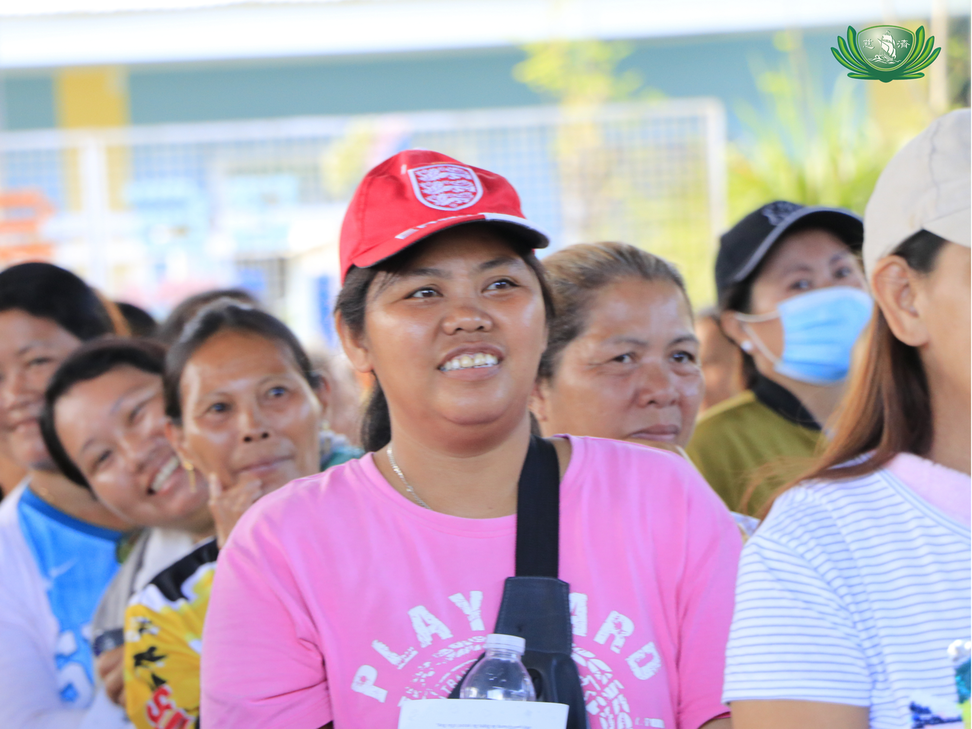 Beneficiaries show grateful smiles during the relief distribution.