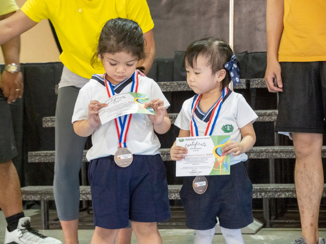 Students admire the medals and certificates they received during the sports fest.