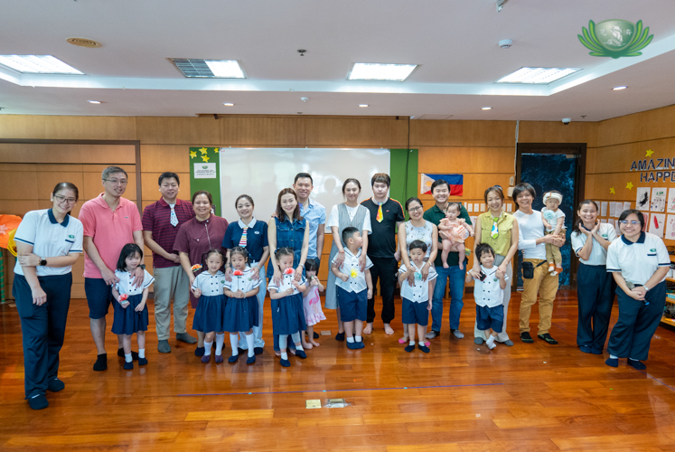Families and teachers pose for a photo after a successful Filial Piety celebration.