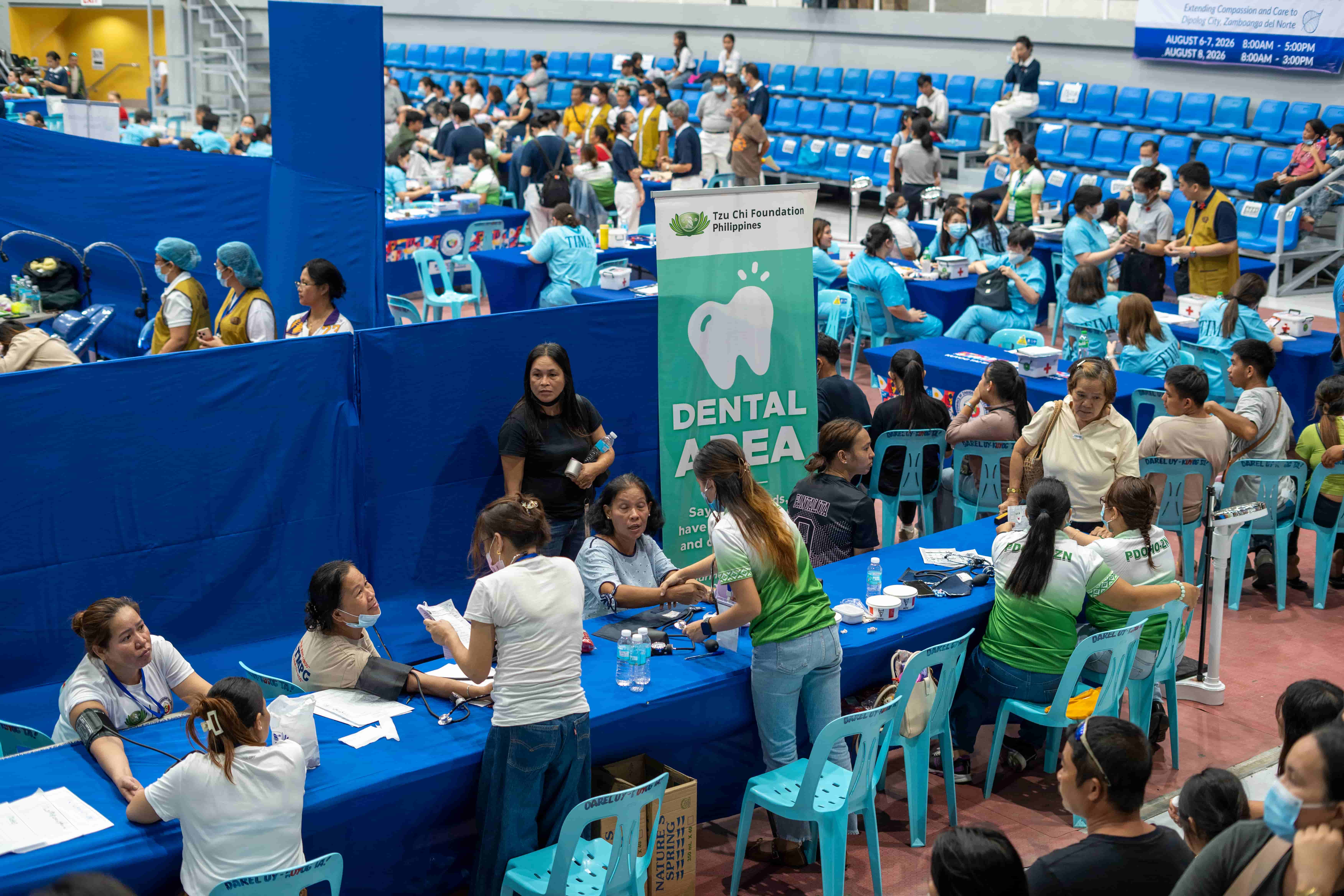 LGU volunteers assist in the triage area, checking patients’ weight, height, and blood pressure.