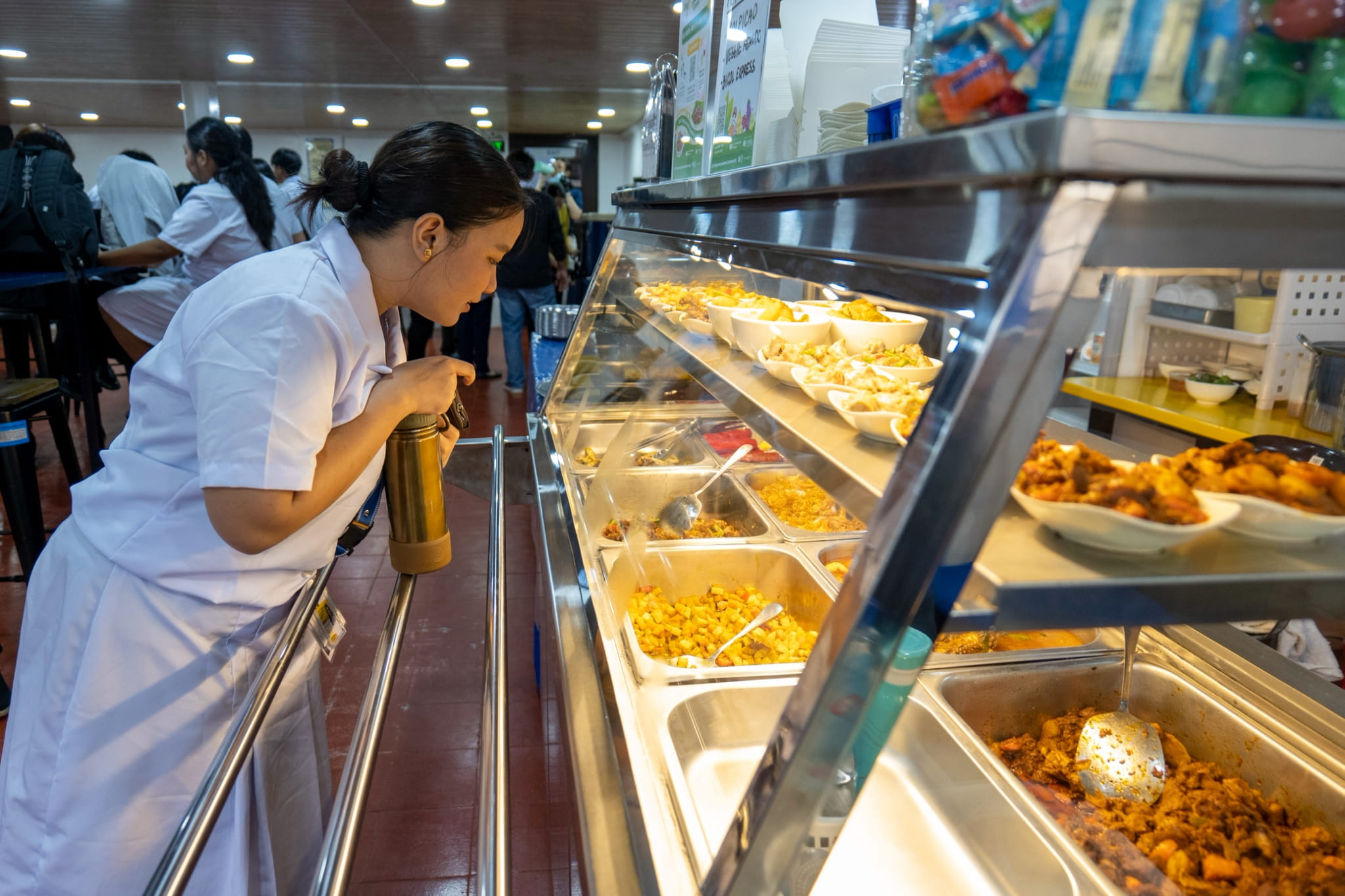 Collette Cuarteros enjoys the expanded plant-based menu as she chooses her lunch.