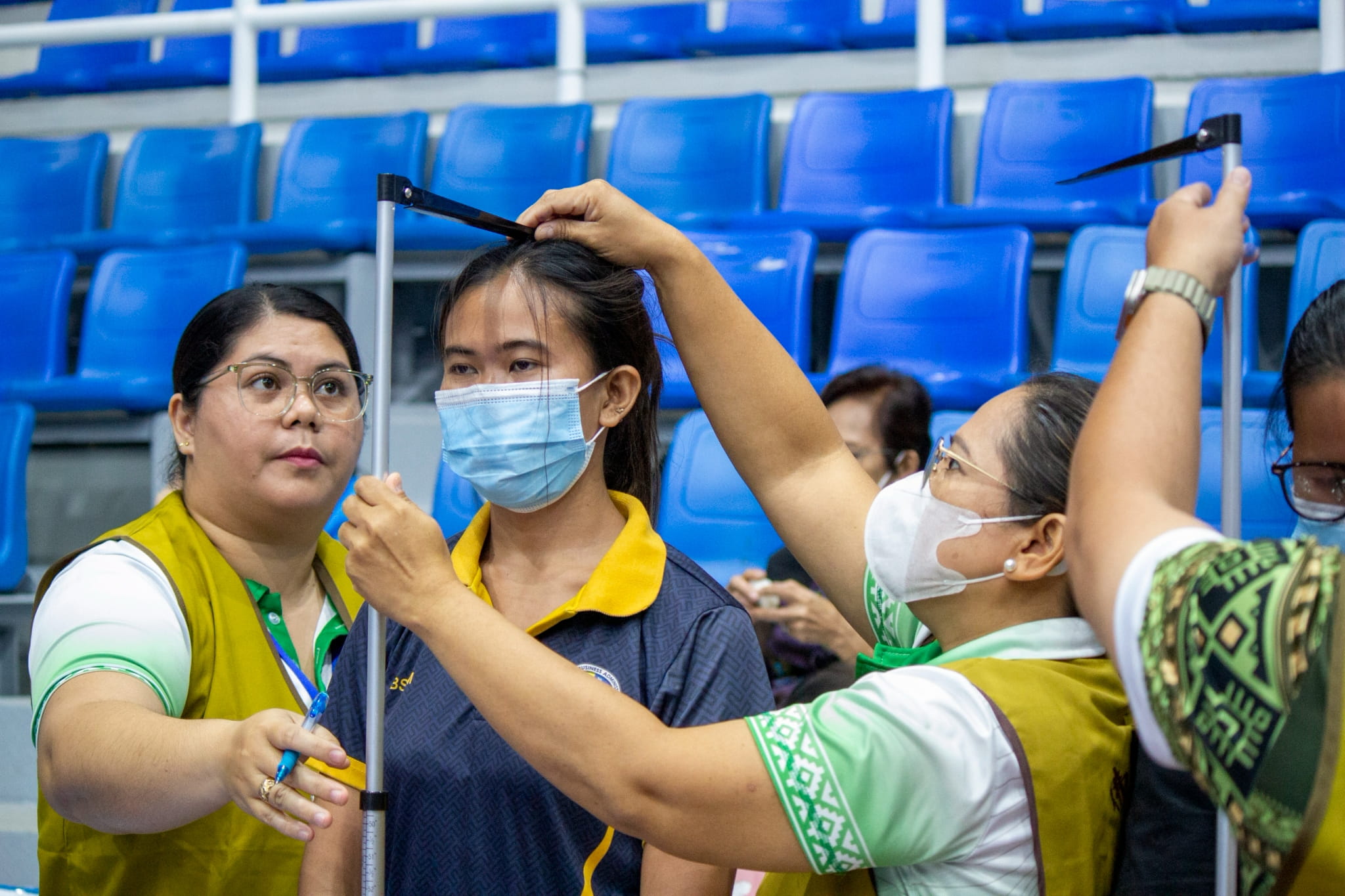 LGU volunteers assist in the triage area, checking patients’ weight, height, and blood pressure.