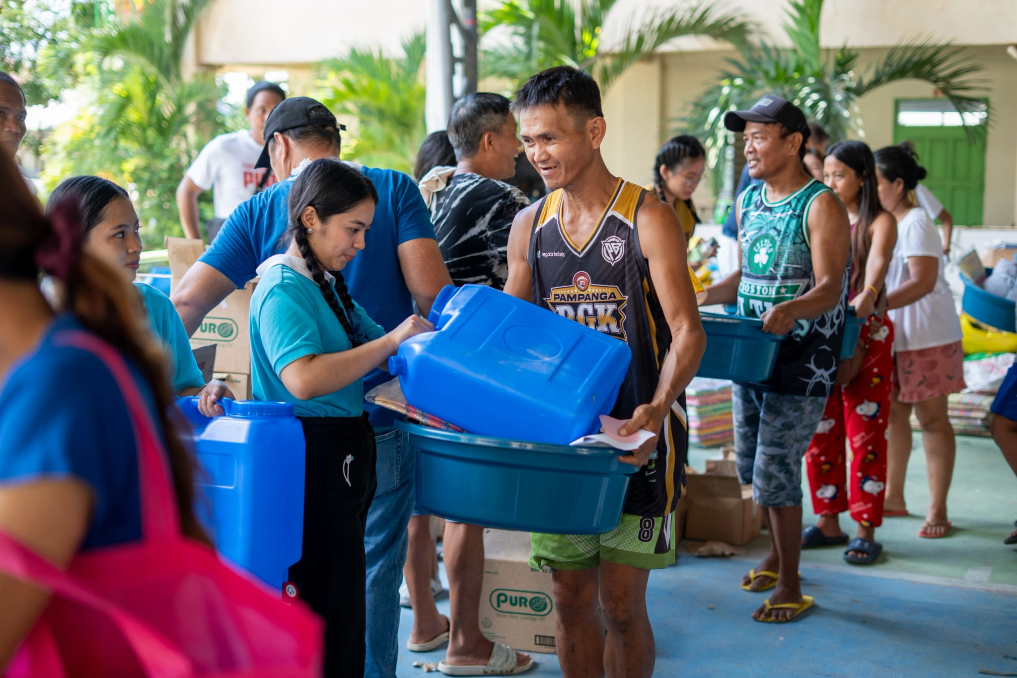 Smiles brighten the faces of beneficiaries as they receive their relief items.