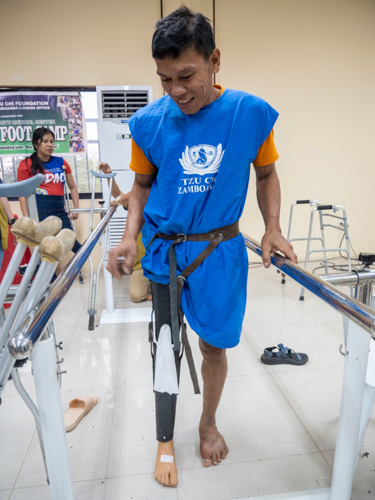 Rodello Garillo tries to walk using his prosthesis during the turnover of 97 artificial limbs at Tzu Chi’s Jaipur Foot Camp on May 16. The event was held at the executive function hall of the capitol compound of Pagadian City, Zamboanga del Sur.