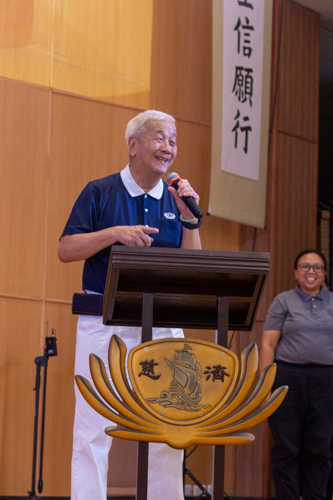 Tzu Chi Charity Department Head Tina Pasion (right) is all smiles as Tzu Chi Philippines CEO Henry Yuñez announces cash awards for scholars graduating with honors. 