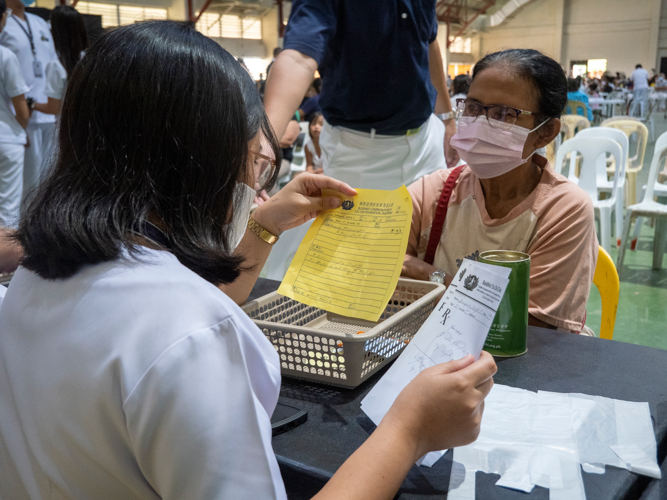 A pharmacist reads the patient’s prescribed medication.