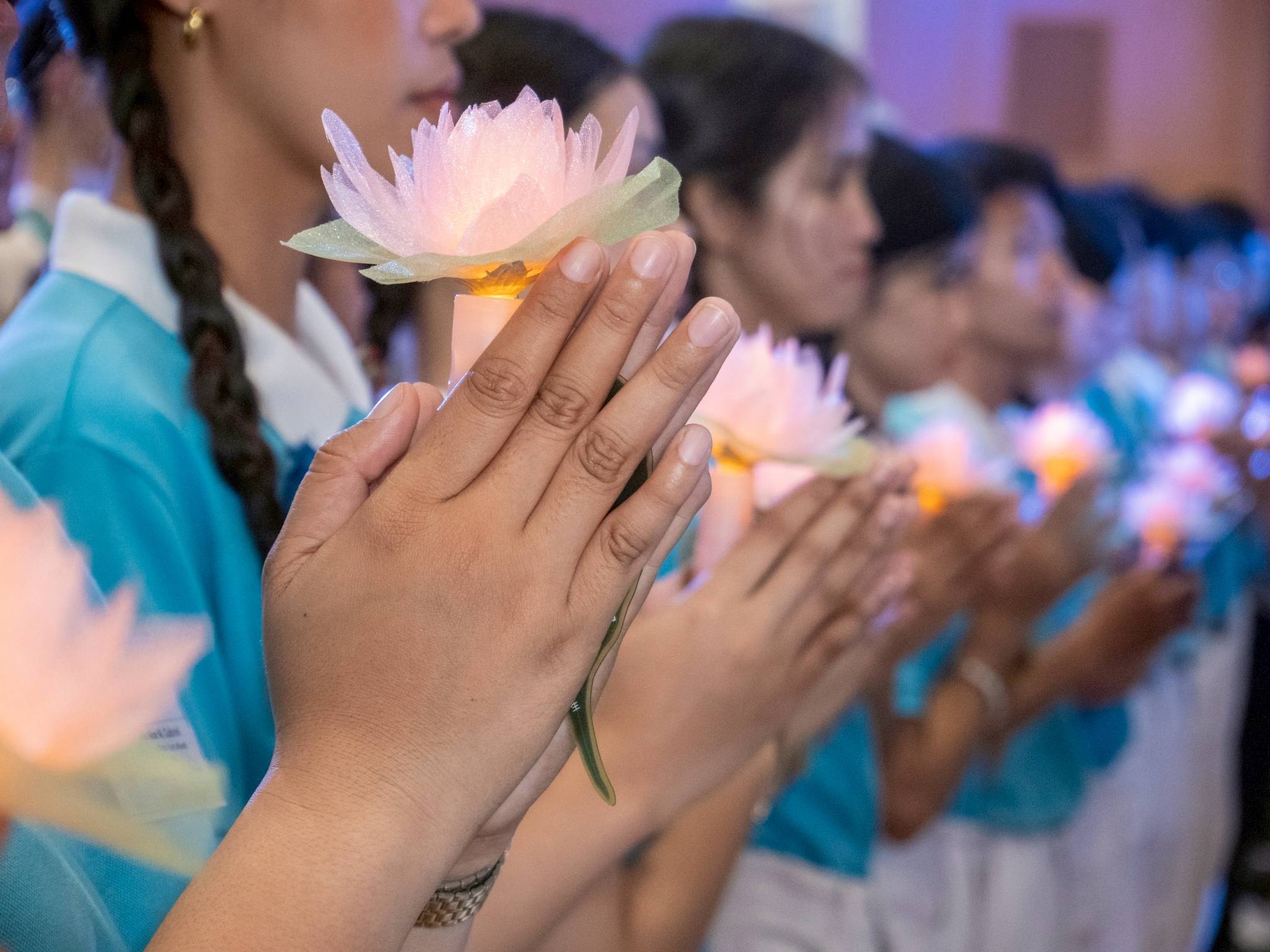 The lit candle symbolizes the light in one’s heart, representing wisdom that dispels ignorance.
