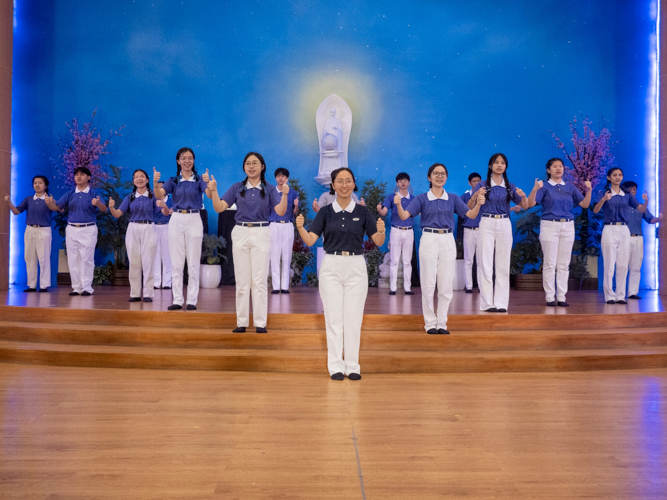 Tzu Chi Youth performs sign language along with a video of Tzu Chi’s three-chapter journey.