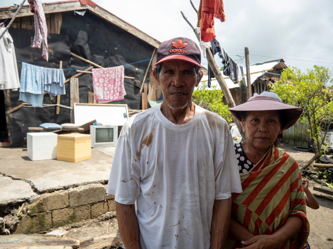 Merly and Fernando Corral of Barangay Umiray stand before their few possessions left after Super Typhoon Karding.【Photo by Harold Alzaga】