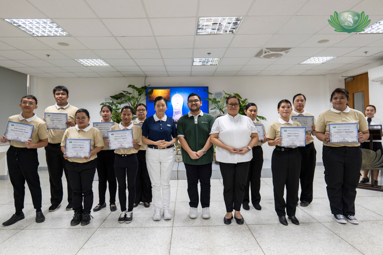 James Llenos (first from left) and fellow caregiving scholars pose with their certificates, Tzu Chi volunteers, and a representative from the Lao Foundation in a simple awarding ceremony in November 2024.