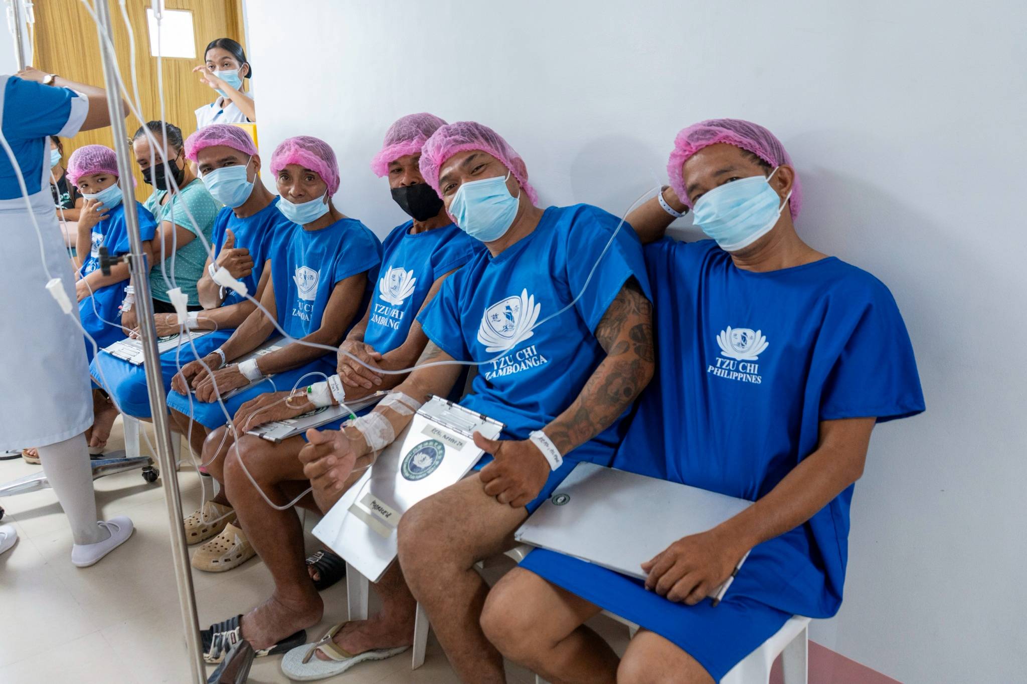 Face masks cannot hide the smiles of male patients awaiting their surgeries. 
