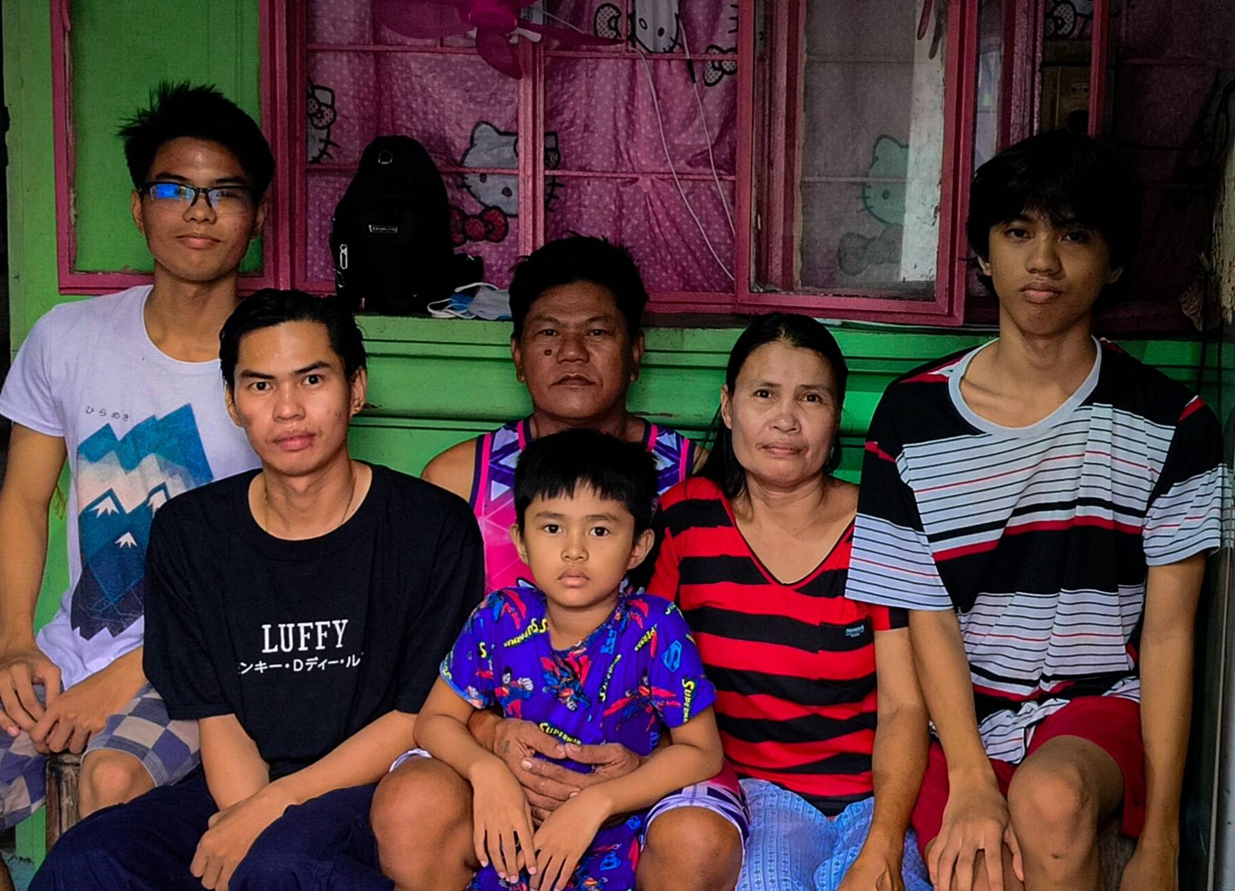 The pillar of his strength: Kenneth Baluyut (far left) shares a portrait together with his family.