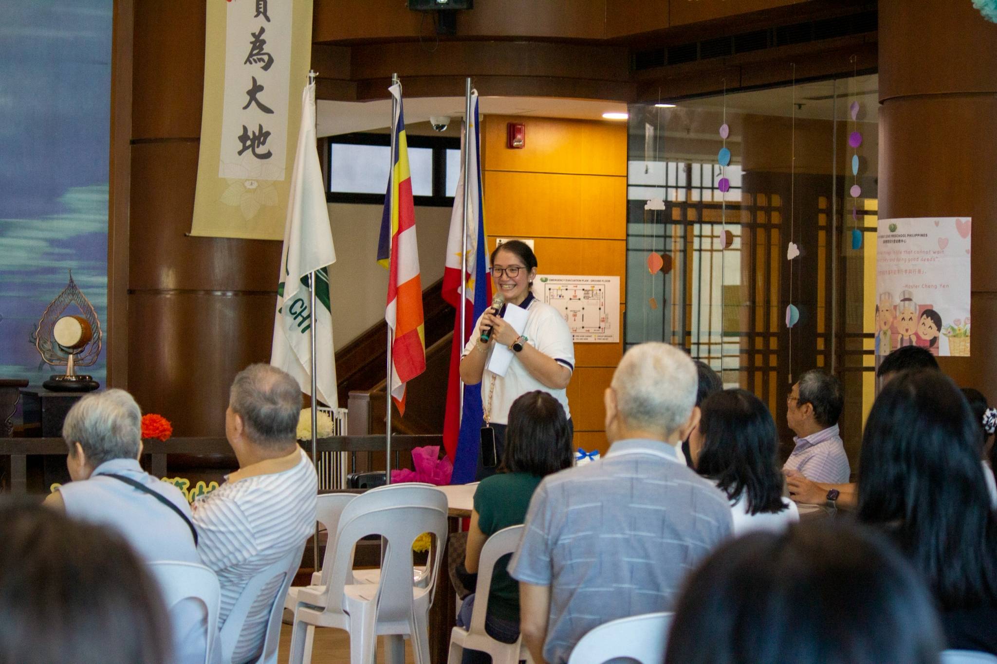 Tzu Chi Great Love Preschool Philippines Directress Jane Sy happily engages with families as she officially opens the event with her welcome address.