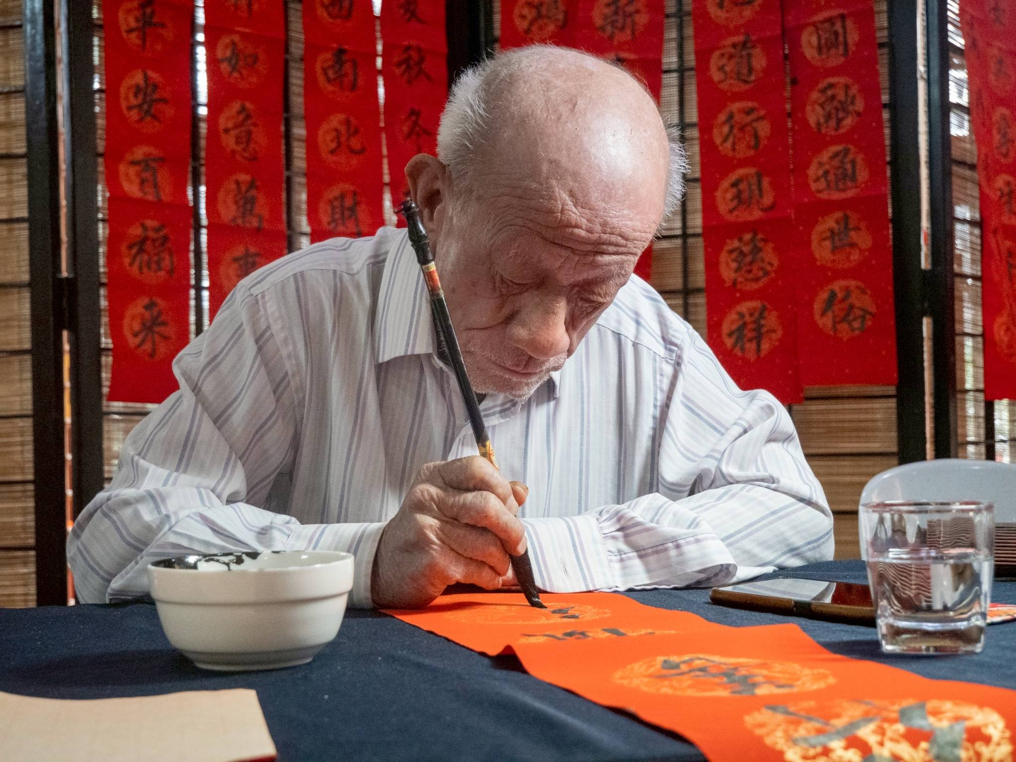 Self-taught calligrapher Chua Hu Hua has been invited to hand-paint scrolls both here and abroad. 
