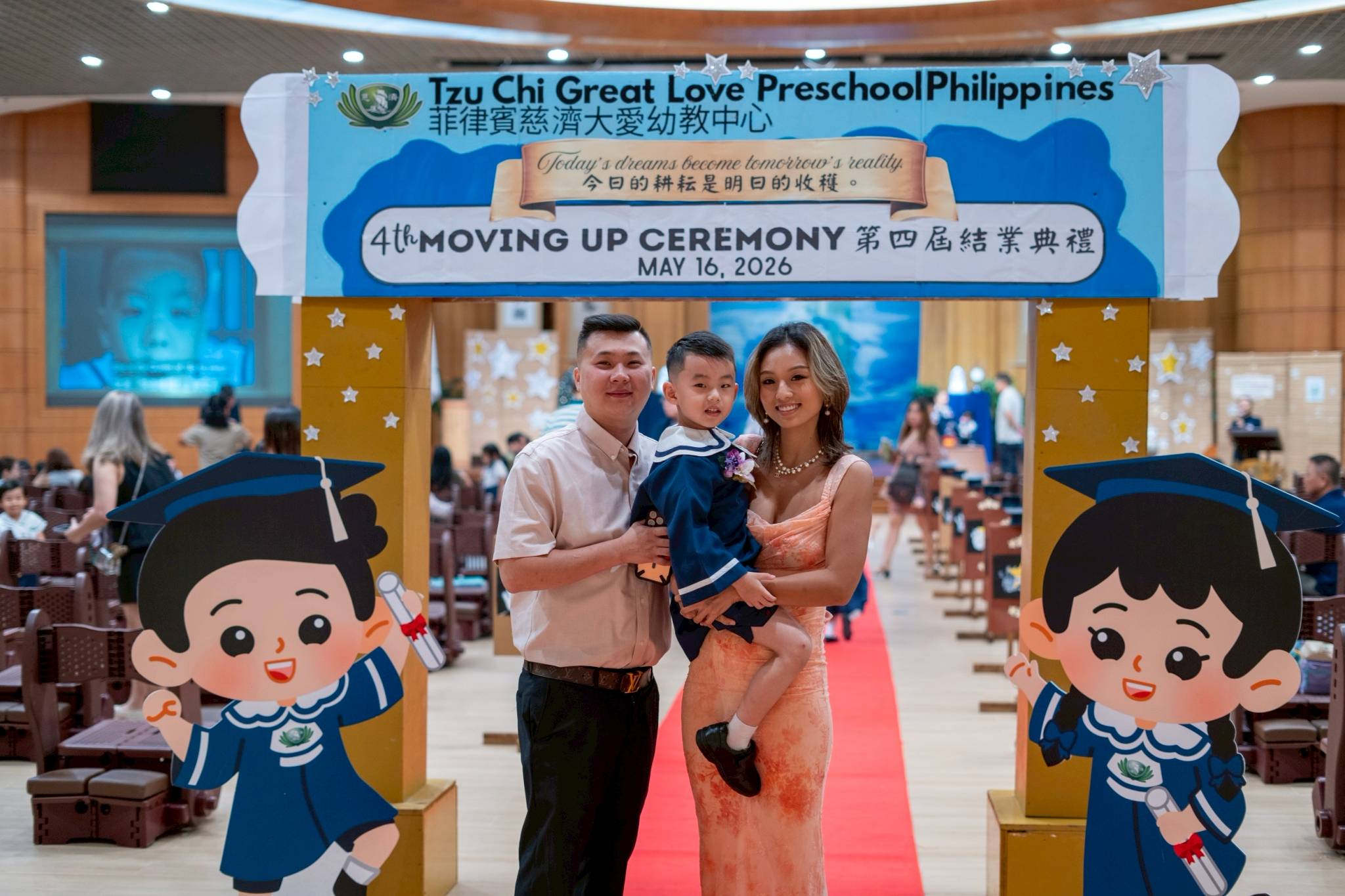 Families pose for pictures before the start of the Moving Up Ceremony.