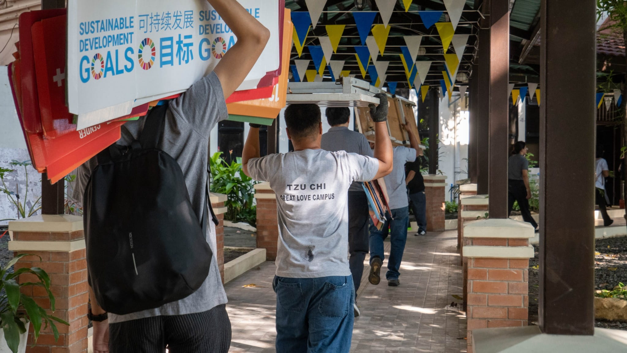 Tzu Chi staffers and volunteers arrive early to set up the canopy and displays.