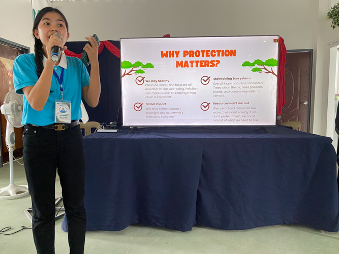 Trixie Mae Masocol teaches the youth about the importance of environmental protection.