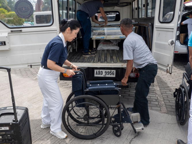 Tzu Chi volunteer Pansy Ho assists in delivering one of two wheelchairs donated to Munting Tahanan ng Nazareth.