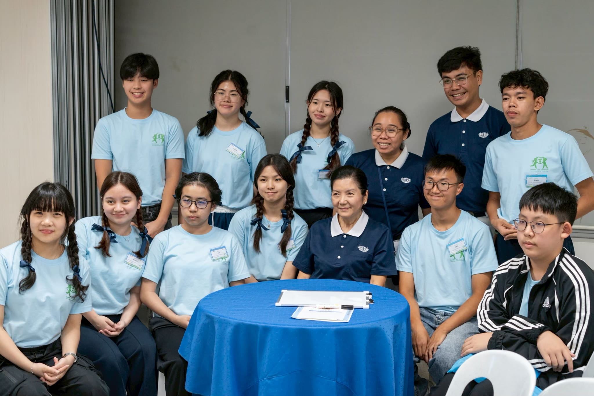 (Seated, third from right) Sharing her volunteer story with participants at the Tzu Chi Youth Camp in June