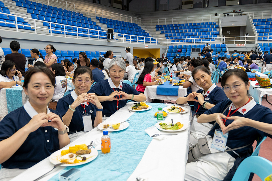 Pausing from their meal for a quick photo, volunteers send love and warm smiles to the camera.