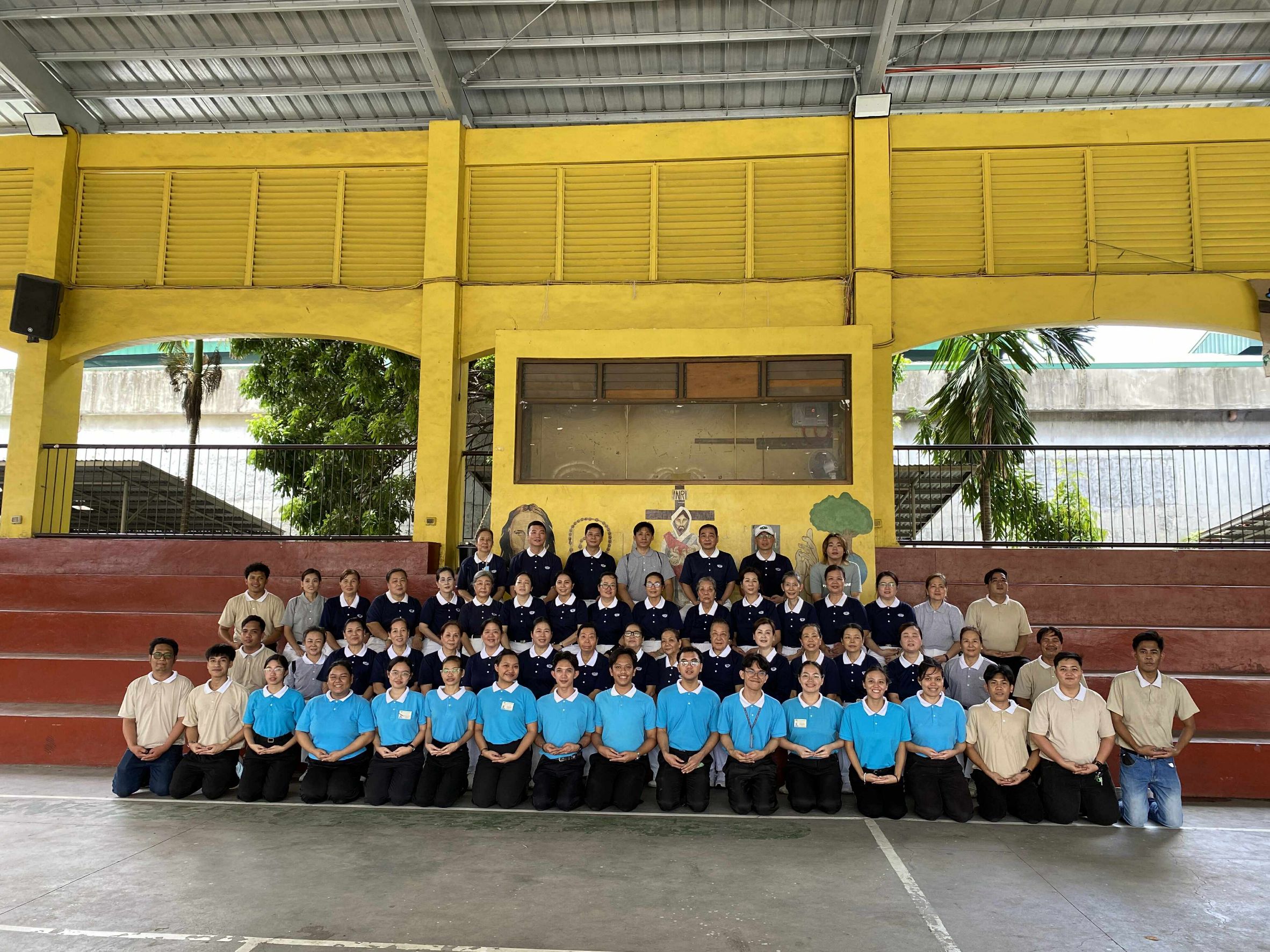Tzu Chi volunteers and scholars pose for a group photo after a successful relief.